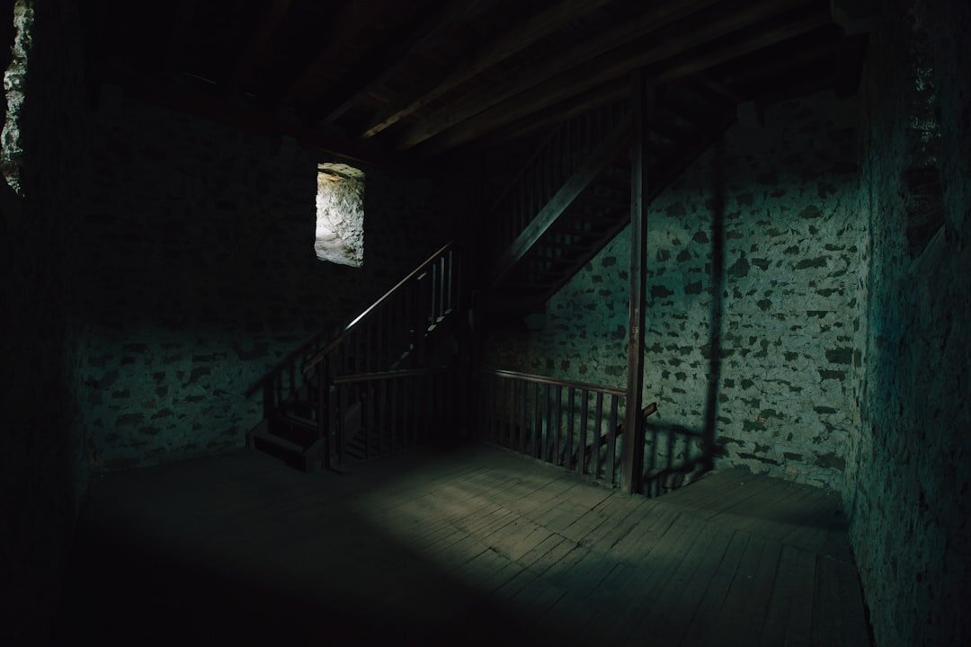 Interior design detail of a wooden staircase and stone wall
