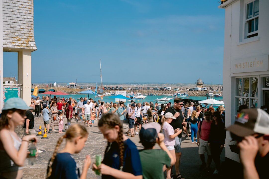 Guests mingling at an outdoor evening event by the sea