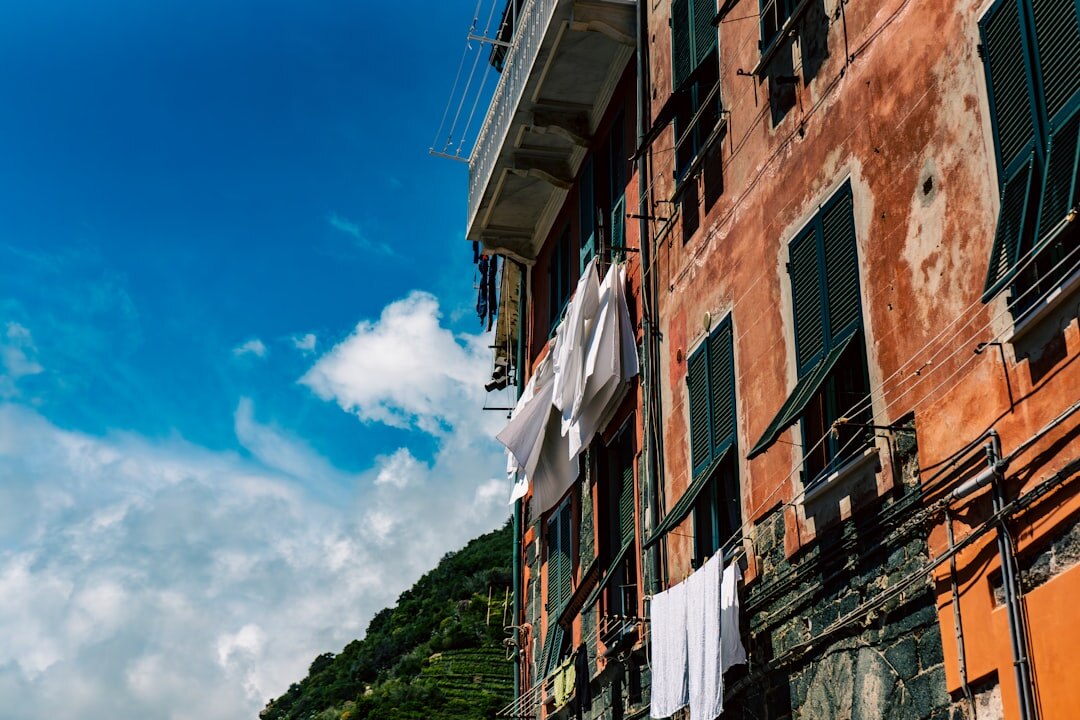 Selected editorial photograph of a coastal alley with hanging laundry