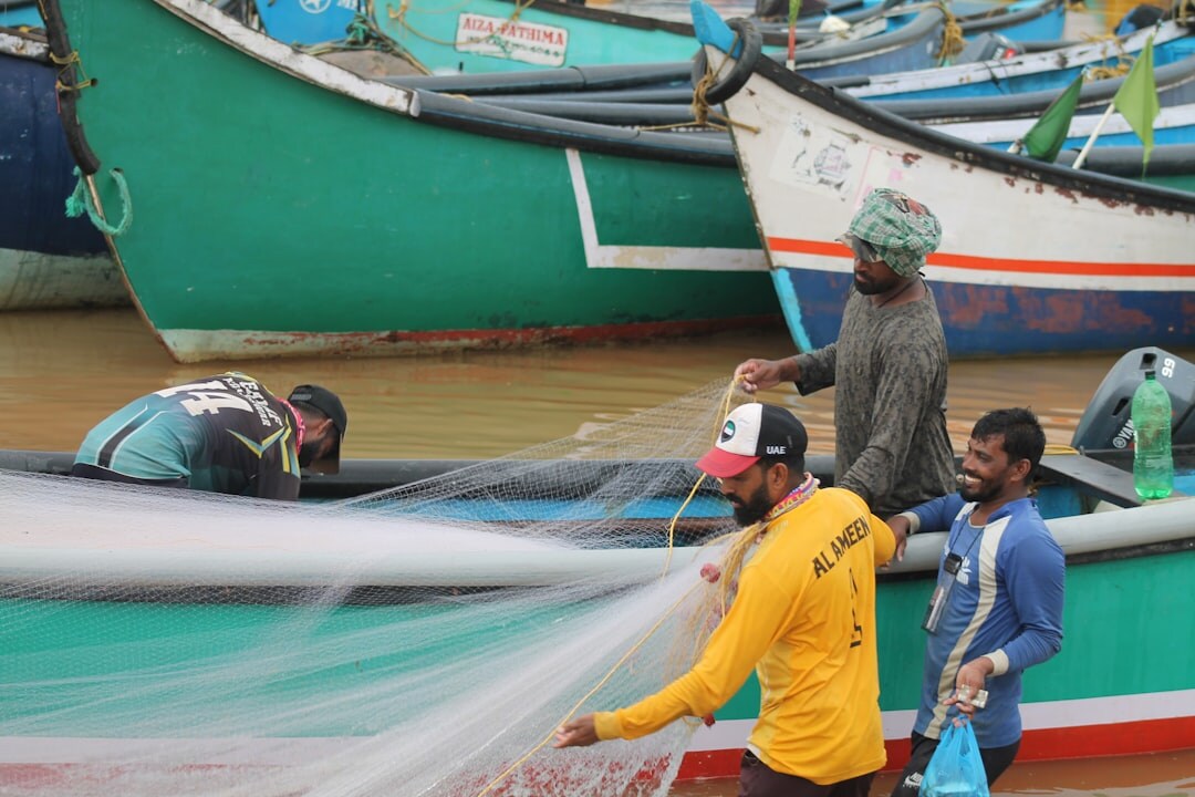 Selected editorial photograph of fishermen sorting the daily catch